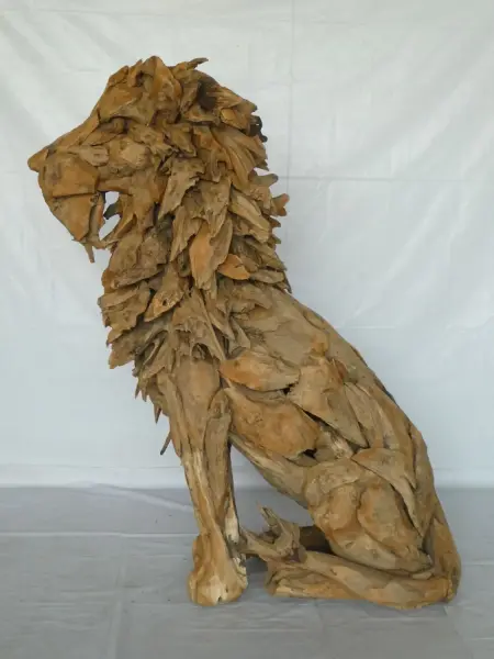 Product image of the product “Seated royal Lion made from teak root pieces. About 100cm length and 150cm height. ”